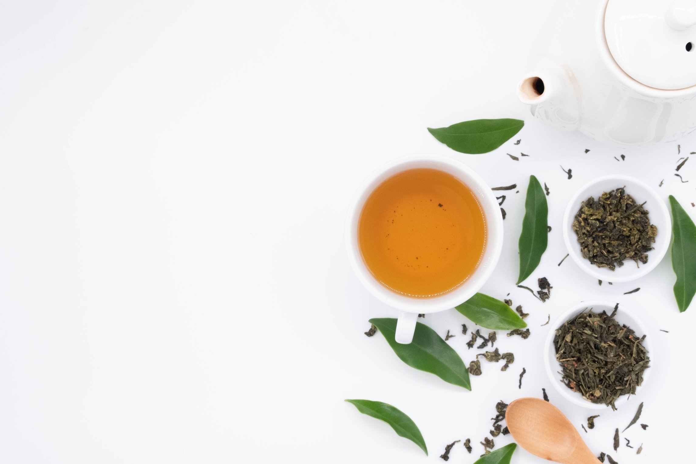 Green tea with leaves on white background